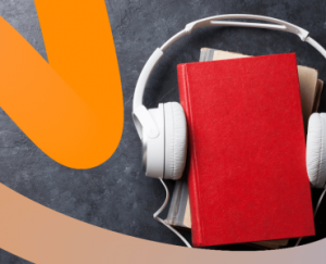 a red book with headphones on top of it