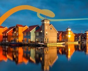 a picture of some houses and a body of water