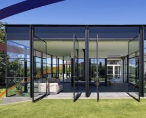 a glass walled room with a couch in it