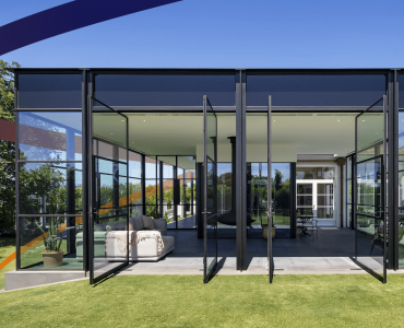 a glass walled room with a couch in it