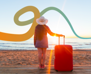 a woman standing on a beach next to a red suitcase