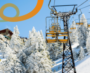 a ski lift going up a snowy mountain
