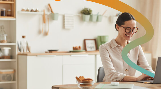 a woman sitting at a table with a laptop