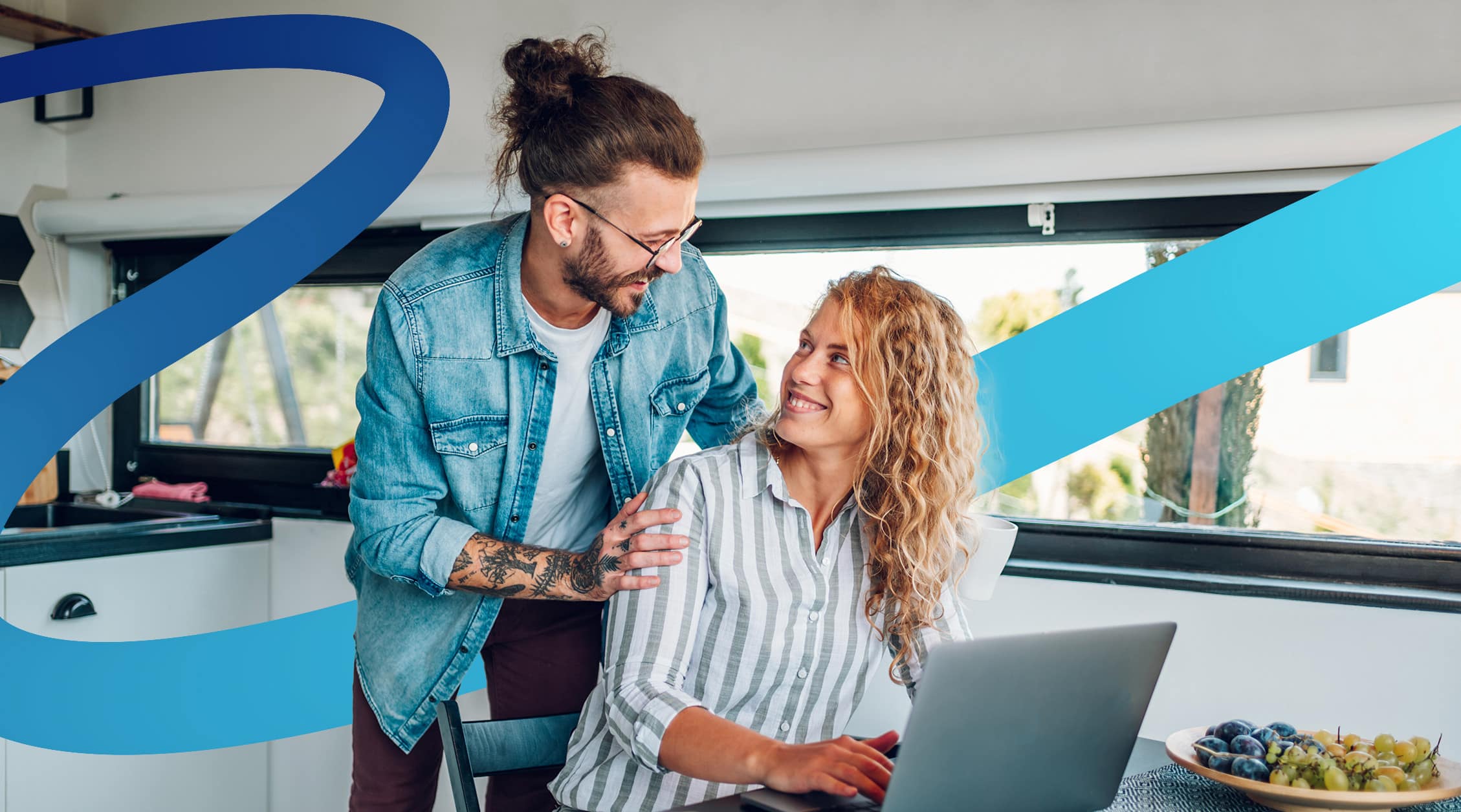a man and a woman looking at a laptop