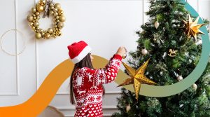 a woman decorating a christmas tree with a star